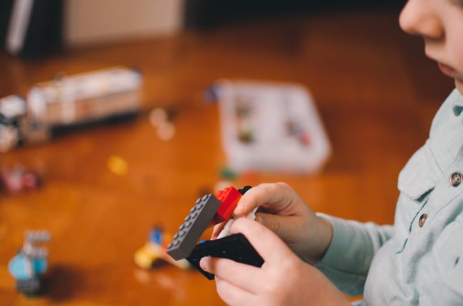 Little kid playing with legos