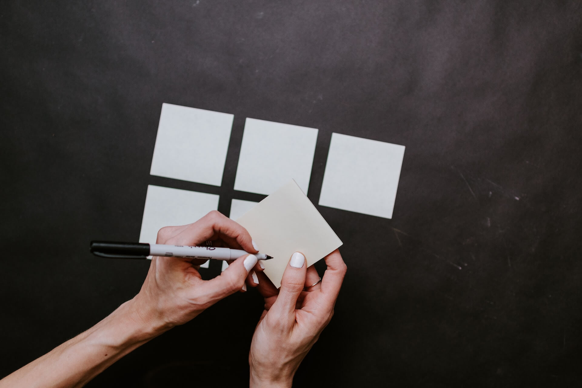 a person holding sticky note